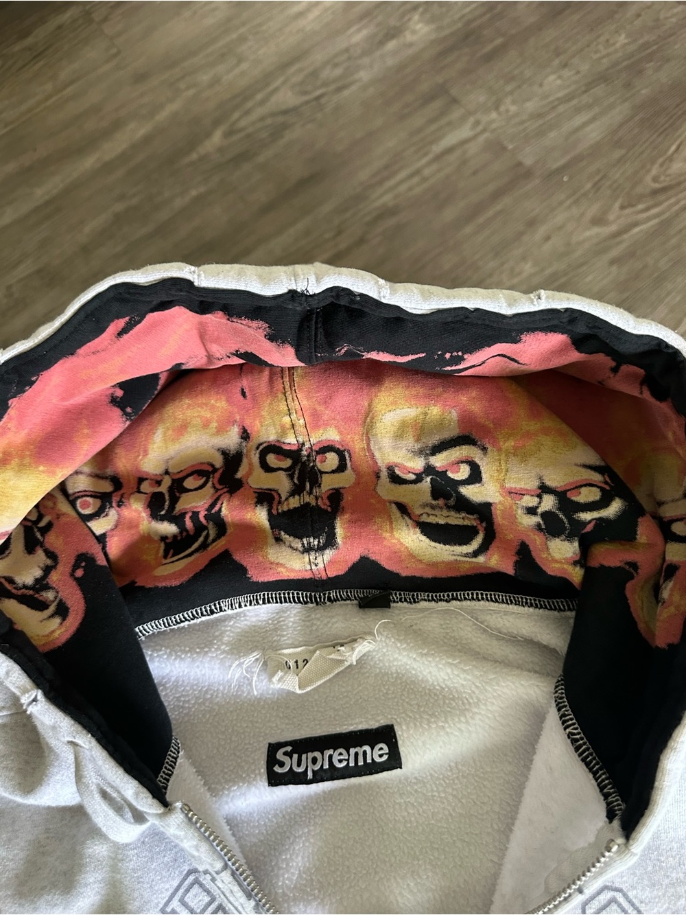 Supreme White Zip-Up Hoodie with Pink and Yellow Skull Lining